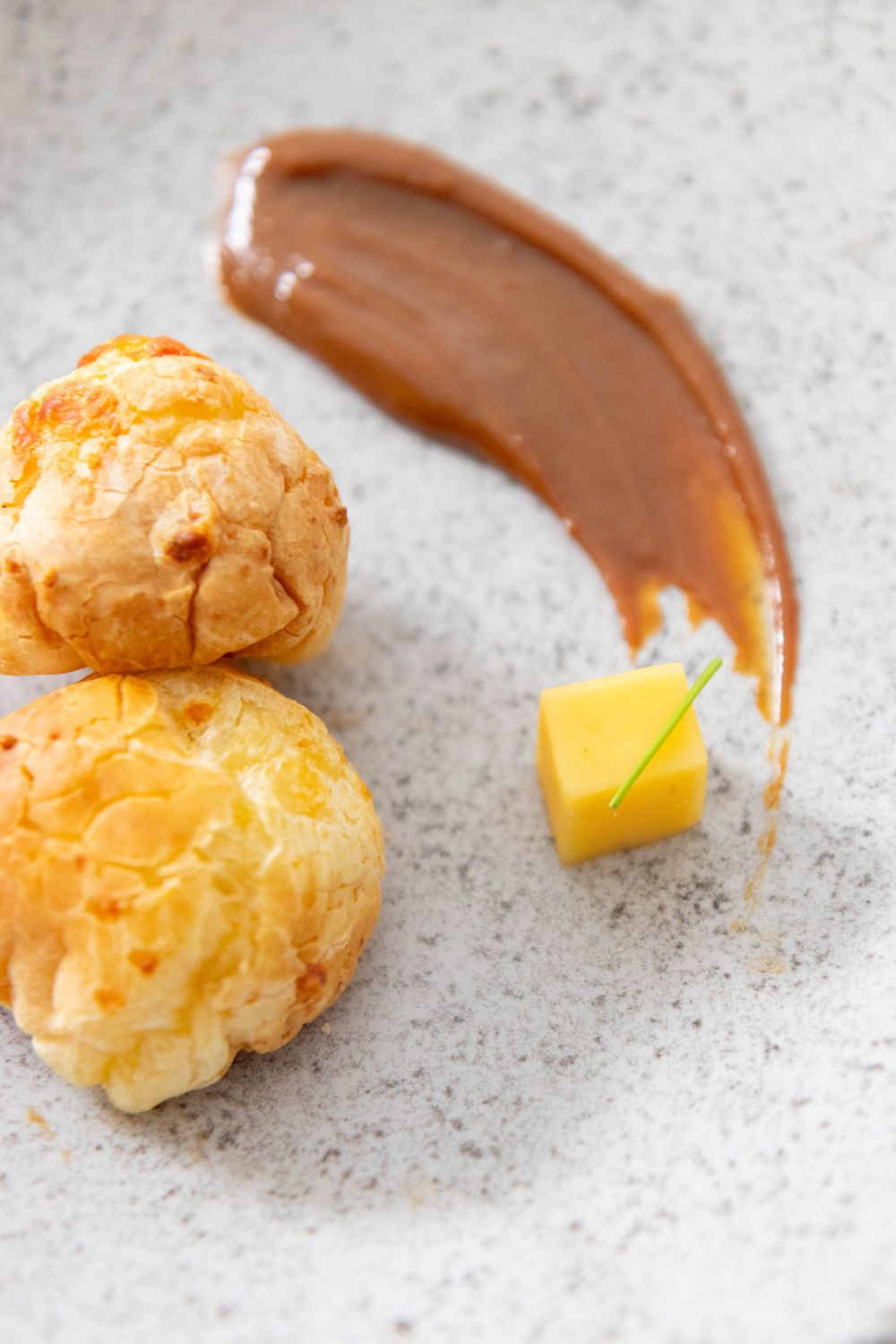 Delicious pastry with caramel and cheese garnishing on elegant plate.