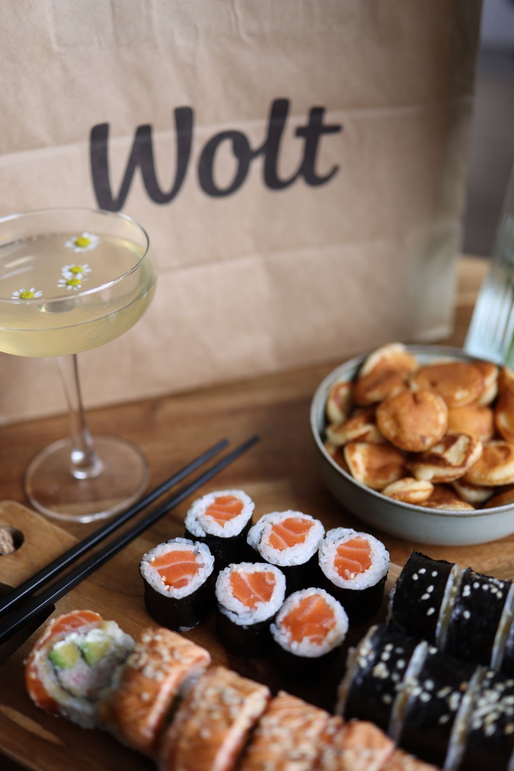 Elegant sushi platter with cocktail, perfect for dining indoors.