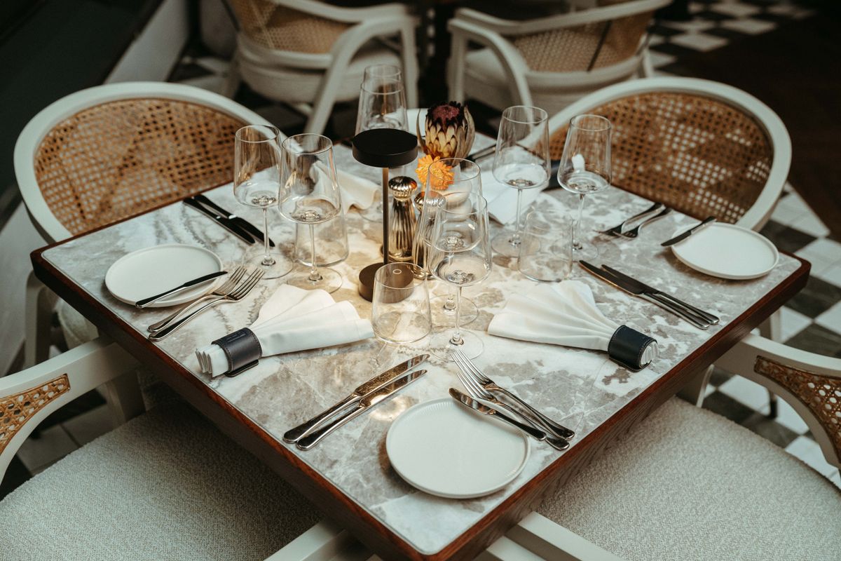 Elegantly set dining table in a Cape Town restaurant featuring stylish tableware and ambient lighting.