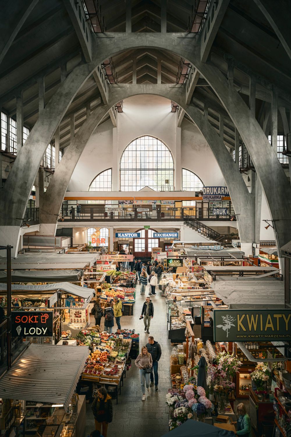 Explore the vibrant halls of Wrocław's indoor market, capturing local life.