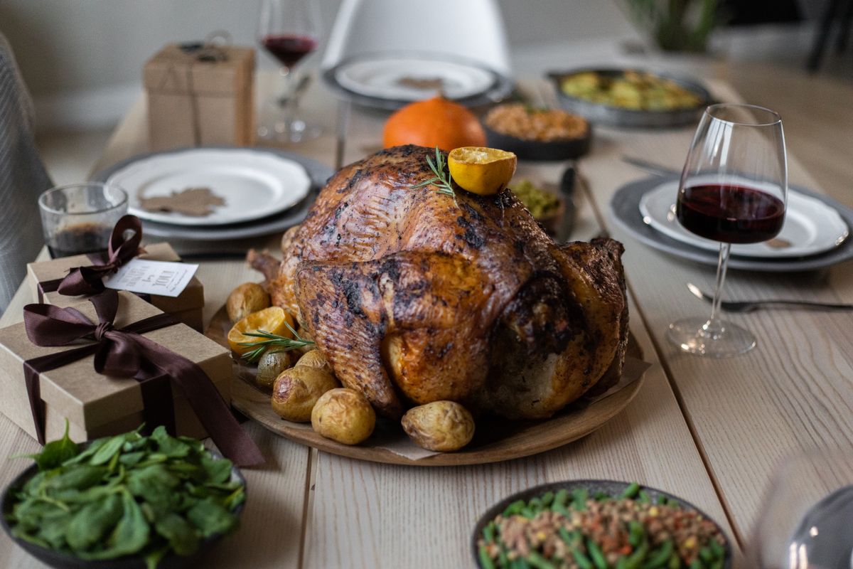 10 Thanksgiving Foods TSA Will Let You Carry On and 6 It Won’t 1 High angle of appetizing roasted turkey and glasses of wine with other dishes placed on wooden table prepared for celebrating Thanksgiving Day