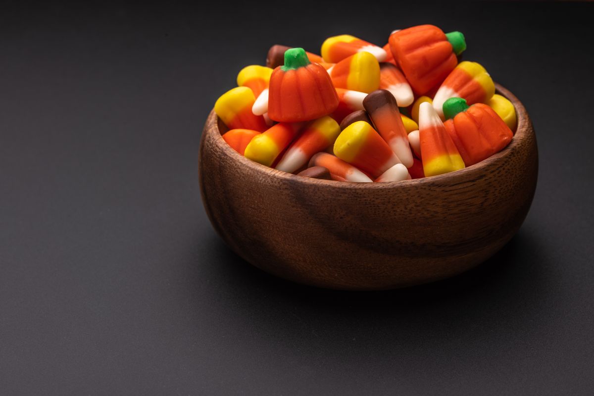 A $29 Bag of Reese’s? Halloween Candy Has Become the Scariest Thing in the Aisle 2 High angle of wooden bowl with sweet marmalade sweets placed on gray surface
