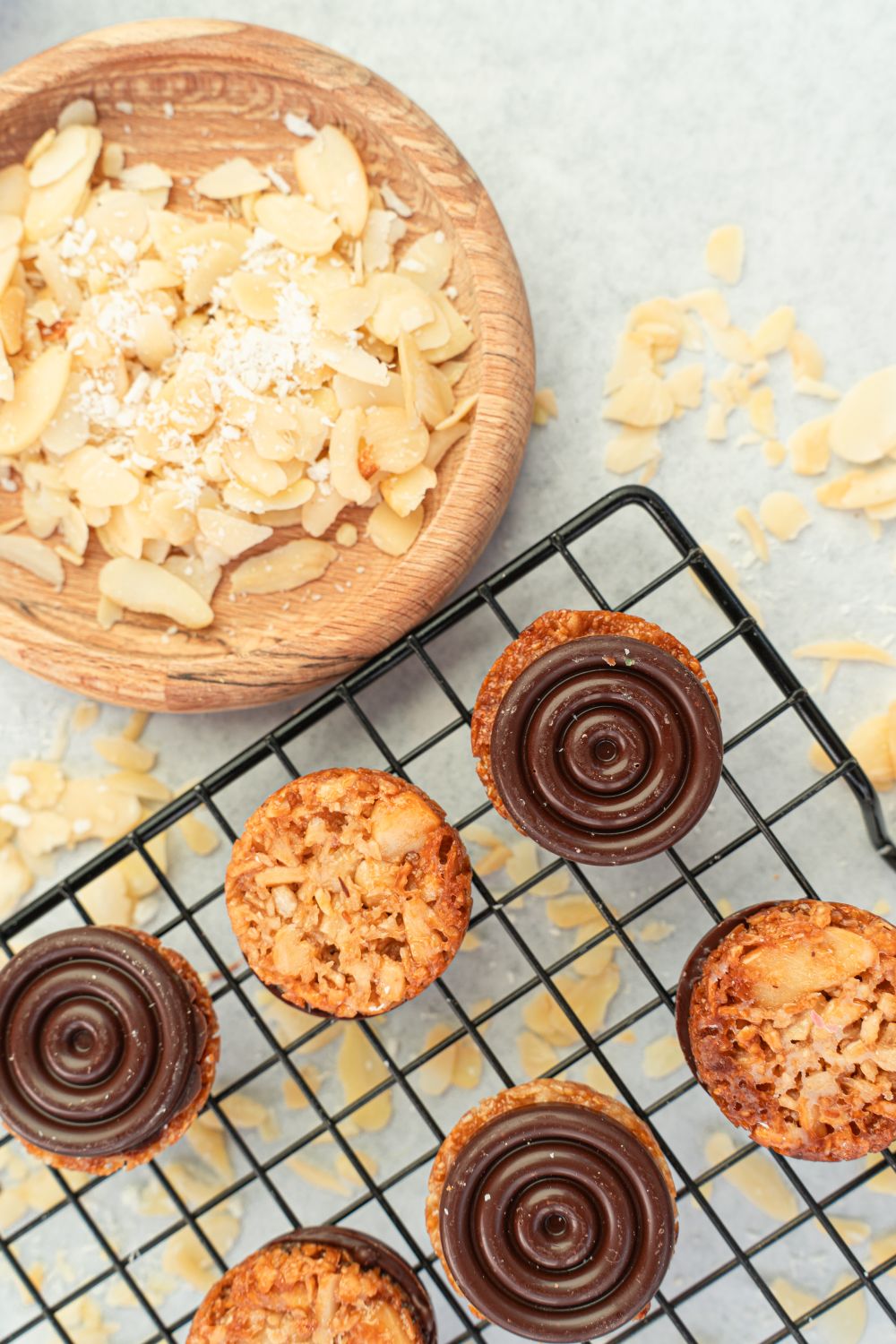These Chocolate-Kissed Florentines Look Straight From a Bakery, and They Start in a Saucepan 2 Indulge in nutty chocolate tarts with almond slivers, ideal for dessert lovers.