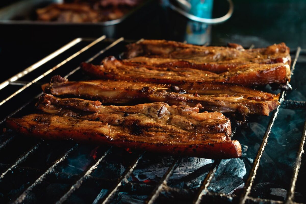 The Forgotten Pantry Ingredient That Makes Pork Chops Taste Richer and Sweeter 2 grilling-pork-belly-slices-on-charcoal-grill-