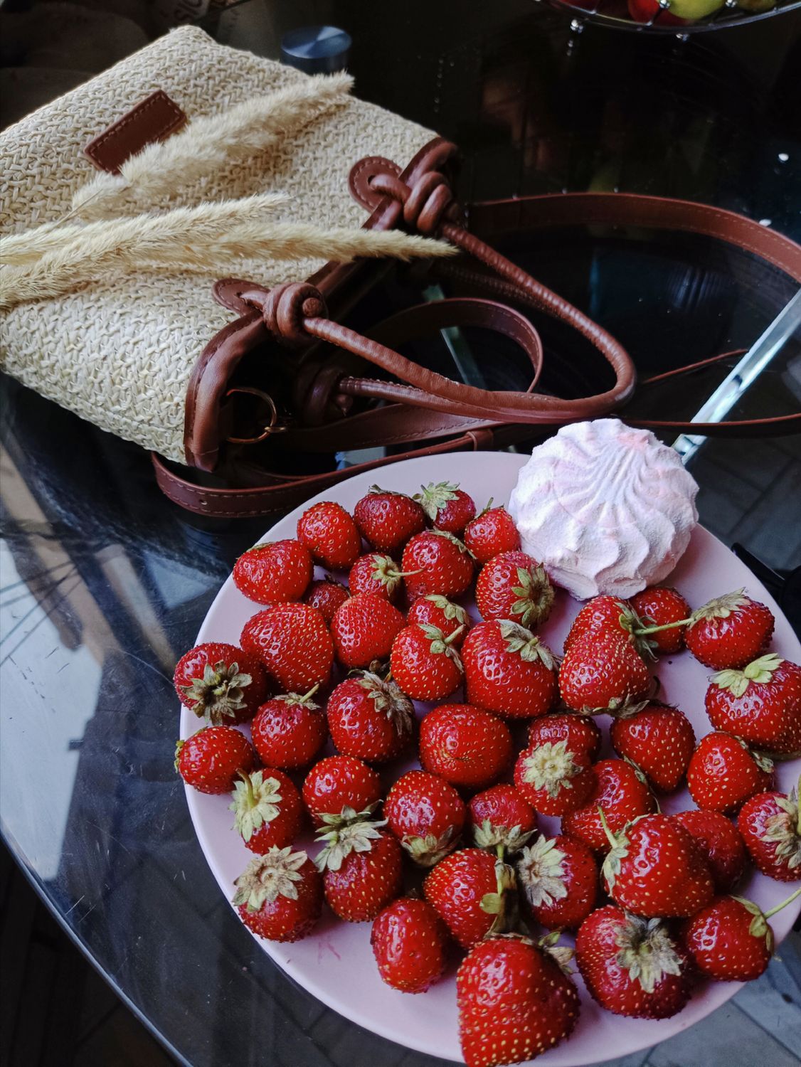 These Homemade Strawberry Marshmallows Get Their Pretty Pink Color From Real Fruit 1 Plate of fresh strawberries and a marshmallow on a glass table with a stylish straw bag.