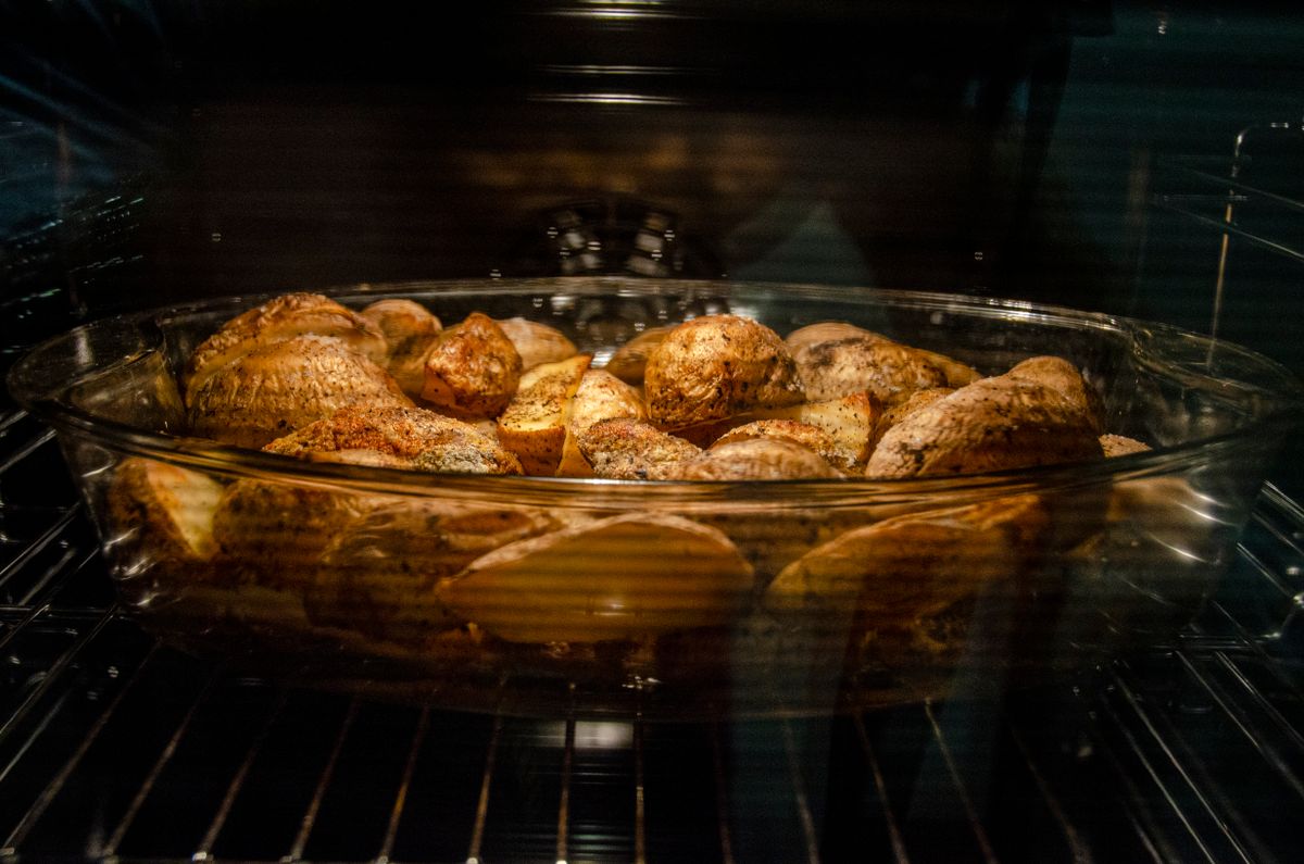 Think You Don’t Like Fennel? A Hot Oven Might Change Your Mind 1 Through glass of appetizing unpeeled spicy potatoes in dish roasting in oven at home