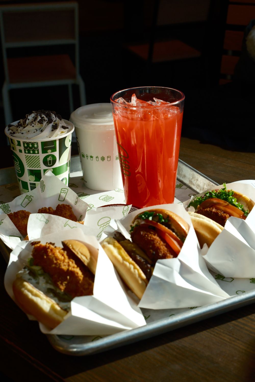 Tray with assorted fast food items and refreshing drinks, ideal for lunch or snack.
