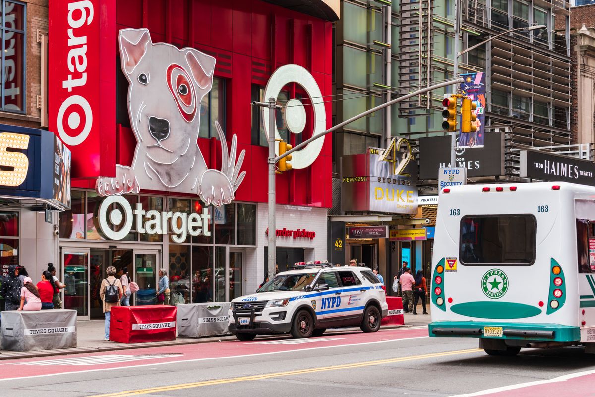 Target Is Adding 8 New Stores This Fall, and Your Next Target Run Could Be a Lot Closer 1 Vibrant street scene in Times Square featuring Target storefront and NYPD car, New York City.