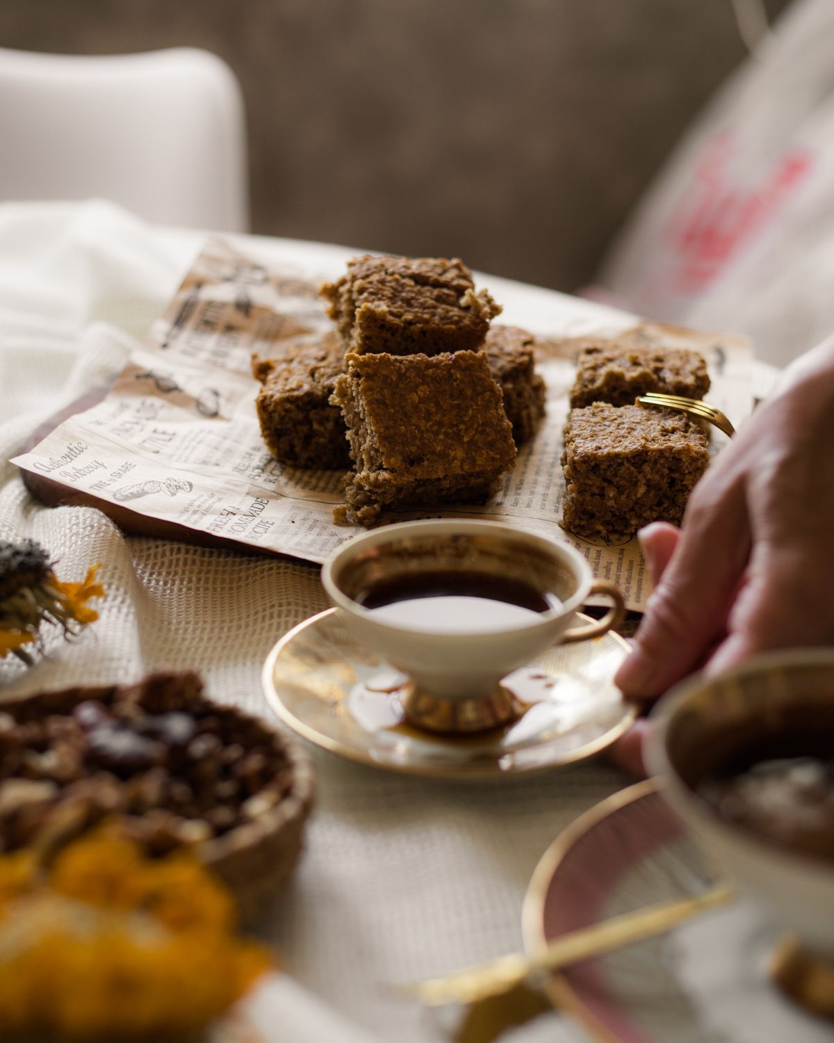 Warm morning scene with a cup of coffee and homemade granola squares, capturing a cozy breakfast ambiance.